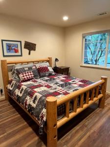 a bedroom with a wooden bed and a window at Wonky Donkey Den 30 mi to Yosemite Arch Entrance in Mariposa
