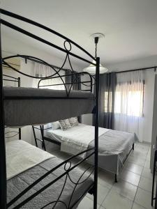 a bedroom with two bunk beds in a room at Chalkidiki Apartment Kallikratia Maria in Nea Kalikratia