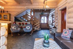 a living room with a couch and a staircase at Willa u Jadzi in Zakopane