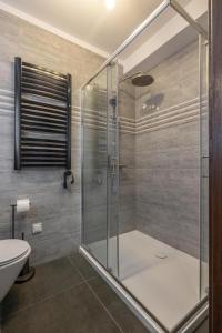 a bathroom with a glass shower and a toilet at Solaris Apartment Nala in Darłowo