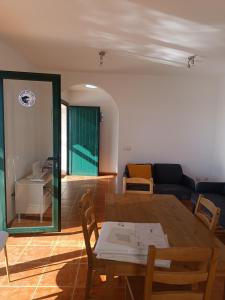 a living room with a table and a couch at MOANA SURF HOUSE in Corralejo