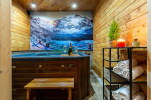 a bathroom with a tub and a painting on the wall at Willa u Jadzi in Zakopane