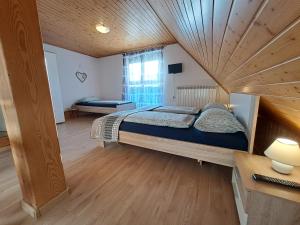 a bedroom with a large bed with a wooden ceiling at Apartments Rupnik in Bovec