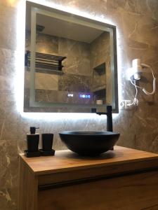 a bathroom with a bowl sink and a mirror at Villa del Sol in Málaga