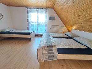 1 dormitorio con 2 camas y ventana en Apartments Rupnik, en Bovec