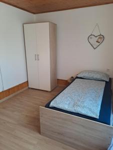 a bedroom with a bed and a closet and a door at Apartments Rupnik in Bovec