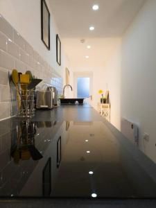 a kitchen with a counter top and a sink at Plenty of Parking Available; 3 Bedroom Apartment by Property Promise in Cardiff