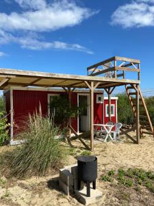 a small house with a canopy and a playground at Luna roja in Punta Del Diablo