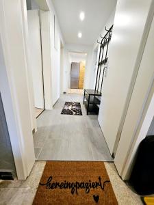 a hallway with a welcome mat on the floor at Pohl Fewo in Remscheid