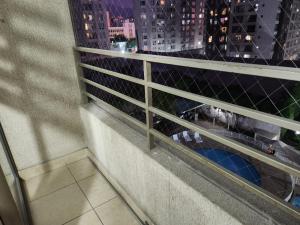 a person sitting on a balcony looking out of a window at Vivaceta Metro Hospitales in Santiago