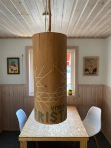 a wooden table with a vase on top of it at Fristad Nature House in Torsby