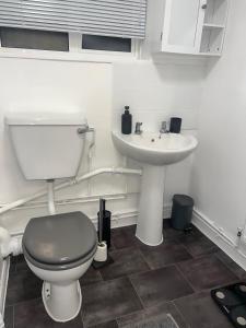 a bathroom with a toilet and a sink at Sleek Cosy Flat Camden in London