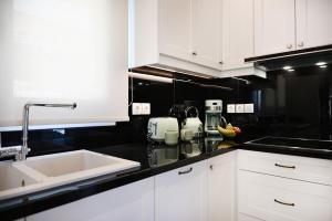 a kitchen with white cabinets and a sink at Villa TheView in Katávolos +48 photos
