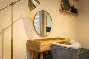 a dressing table with a mirror and a chair at Entire Apartment - City Centre - Free Parking in York
