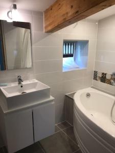 a bathroom with a sink and a tub and a toilet at Gîte mitoyen gorges de la Monne - Olloix in Olloix +18 photos