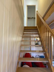 a staircase in a house with wooden rails at Gîte mitoyen gorges de la Monne - Olloix in Olloix