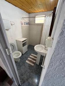 a bathroom with a toilet and a sink at Techos amarillos 3 in Castillos