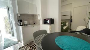a room with a table and chairs and a kitchen at A home in the center of Athens in Athens