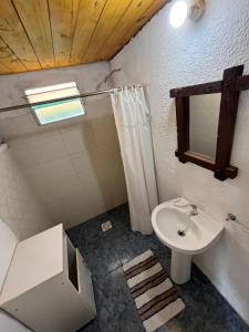 a bathroom with a sink and a shower and a toilet at Techos amarillos 3 in Castillos