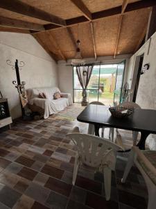 a living room with a table and chairs at Techos amarillos 3 in Castillos
