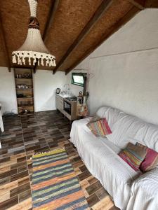 a living room with a couch and a kitchen at Techos amarillos 3 in Castillos