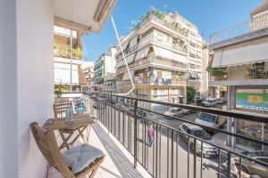a balcony with a chair and a view of a street at Myilios Luxury Petralona Athens Center in Athens