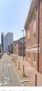 an empty street in front of a brick building at Locatif in Lille