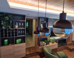 a living room with two large pendant lights at Drop Kop in Brzeće