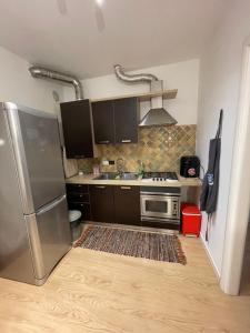 a kitchen with a stainless steel refrigerator and a stove at Garden Love Venice in Mestre