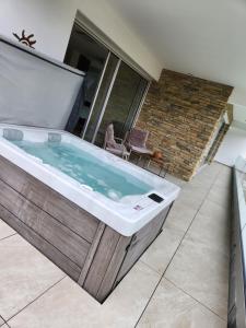 a jacuzzi tub in the backyard of a house at Villa Saint Andrews in Marly