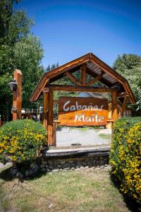 a sign that says calander native in a park at Cabañas Maite in Villa La Angostura