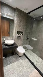 a bathroom with a toilet and a sink and a shower at New Apartment by the Twin Center with Free Parking in Casablanca