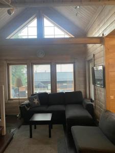 a living room with a couch and a tv at Villa Sappee in Sappee