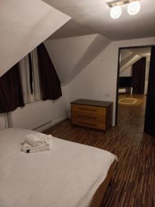 a bedroom with a bed and a dresser and a mirror at Cabana Antonia in Straja