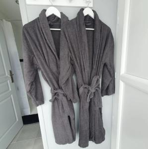 a bunch of towels are hanging in a closet at Cottage de la mare aux chèvres in Reux