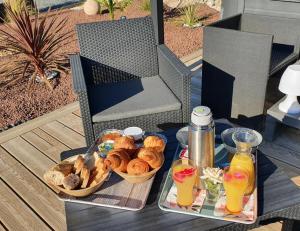 a tray of pastries and drinks on a table at Cottage de la mare aux chèvres in Reux