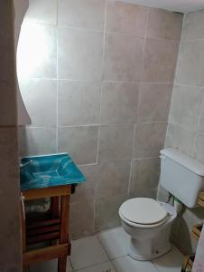 a bathroom with a toilet and a wooden table at Casa tipo cabaña El Faro (con seña) in Mar del Plata
