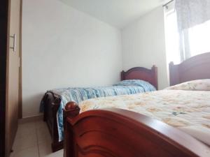 Kama o mga kama sa kuwarto sa Hermoso Apartamento Estancia Tranquila por dias, semanas o meses