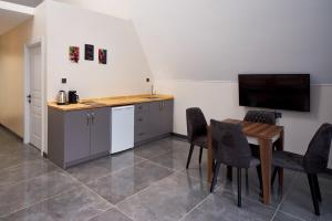 a kitchen and dining room with a table and a television at Timeless Kartepe in Kartepe