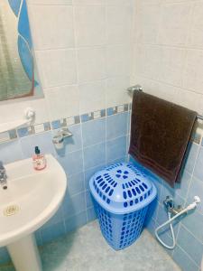 a blue and white bathroom with a toilet and a sink at Dream Appartement El Aouina in Tunis