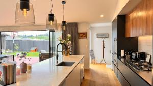 a kitchen with a sink and a counter top at Spacious and Luxurious Family Home in Queenstown