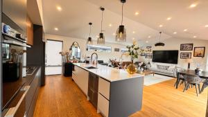 a large kitchen and living room with a couch at Spacious and Luxurious Family Home in Queenstown