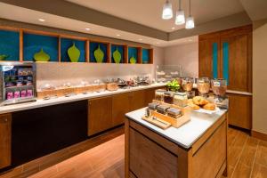 a large kitchen with a breakfast buffet in a restaurant at SpringHill Suites Mishawaka-University Area in South Bend