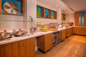a large kitchen with wooden cabinets and a counter top at SpringHill Suites by Marriott Gaithersburg in Gaithersburg