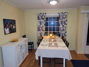 a dining room with a table with a candle on it at Fargerik retro enebolig,parkering på stedet! in Trondheim