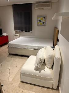 2 Betten und ein Sofa in einem Zimmer in der Unterkunft Exyca Malasaña in Madrid
