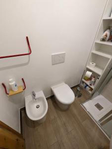 a bathroom with a white toilet and a sink at Le Marmotte - Appartamento in Abetone