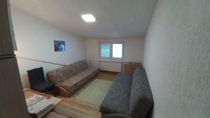 a living room with a couch and a chair at Kopaonik Apartman Aleksandar in Kopaonik +12 photos