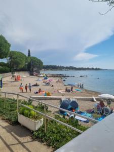 a beach with people on the sand and the water at Villa Melanie in Umag