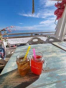 two drinks in mason jars sitting on a table on the beach at Villa Melanie in Umag